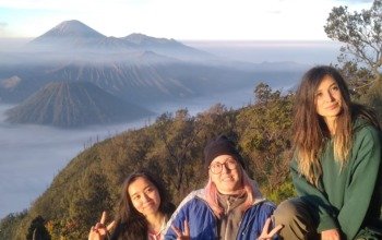 tourist watching sunrise over Mount Bromo
